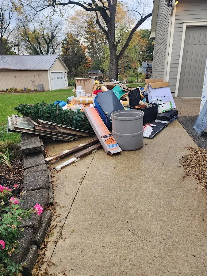 Dumpster being loaded with debris for Estate Cleanout Dumpster Rental in Angola